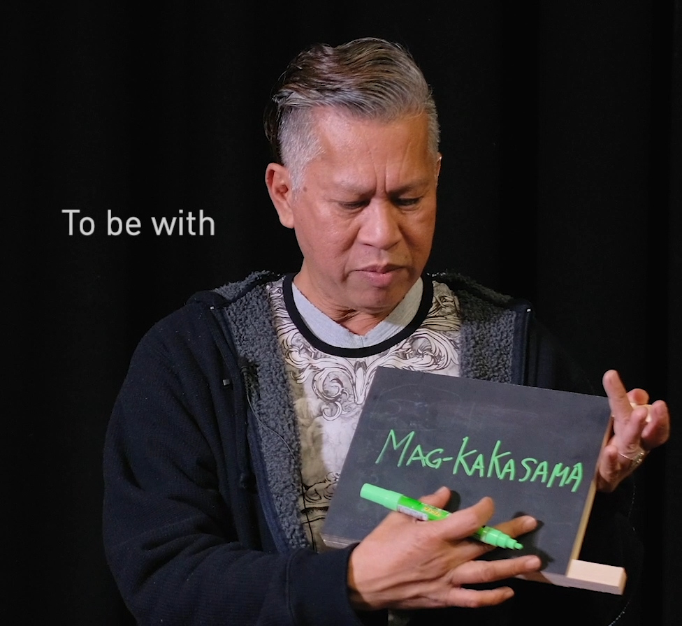 Man holding chalkboard.