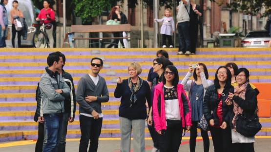 - A group in the Perth Cultural Centre interacting with the big screen of dinosaurs