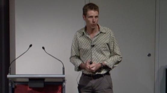 Seahorse tales and pregnant males - Glenn Moore stands at a podium, presenting a lecture