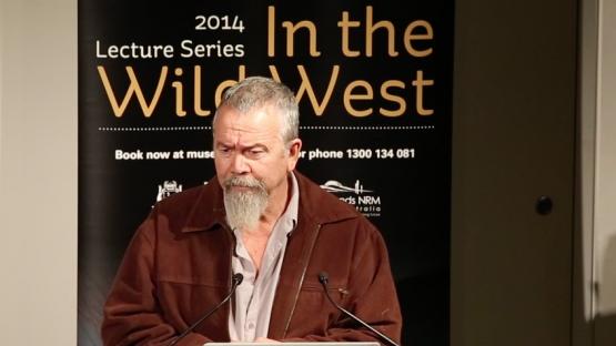 In the wild west lecture with Mack McCarthy - Mack McCarthy presenting at a lecturn