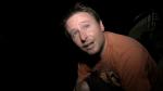 Andrew Hosie up close on the back of a boat at night  