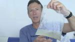 Clay Bryce holding a plastic bag filled with water and an octopus  