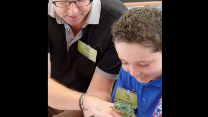 FrogWatch at the WA Museum A child being presented with a live frog
