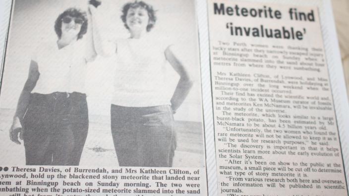 newspaper clipping in photo album reads 'meteorite find invaluable'