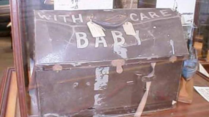 Dog box baby capsule, donated by Mrs Bankoff in 1994 - Photo from WA Museum A piece of luggage, well-used and somewhat battered