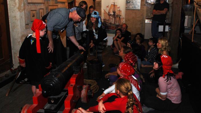 Story time at the Shipwreck Galleries A group of children gathered in a room receiving a lesson
