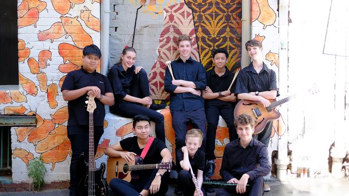 Caption: Electrocity Ensemble "Electrocity posing for a group photo with their instruments."
