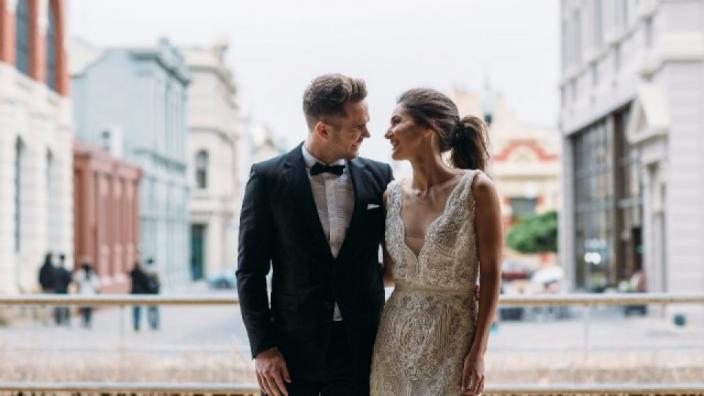 Caption: Fremantle Wedding Walk. "A married couple look at each other lovingly in the heart of Fremantle."