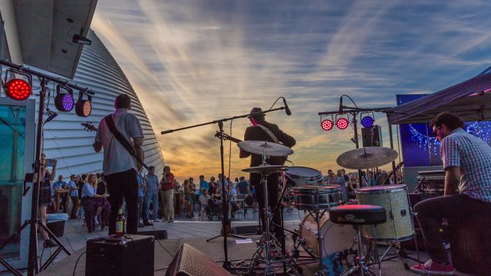 Caption: Harbour Sundays 2017 "A band play to a crowd that are partying on the balcony of the Museum."