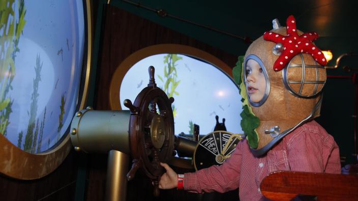 Voyage to the Deep "A child visiting Voyage to the Deep. They are dressed as a deep sea diver."
