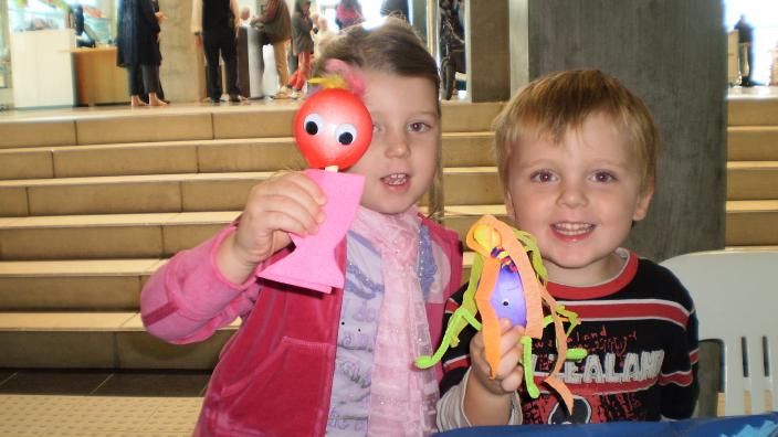 Caption: Intergenerational Play Day. "Two children show their craft."