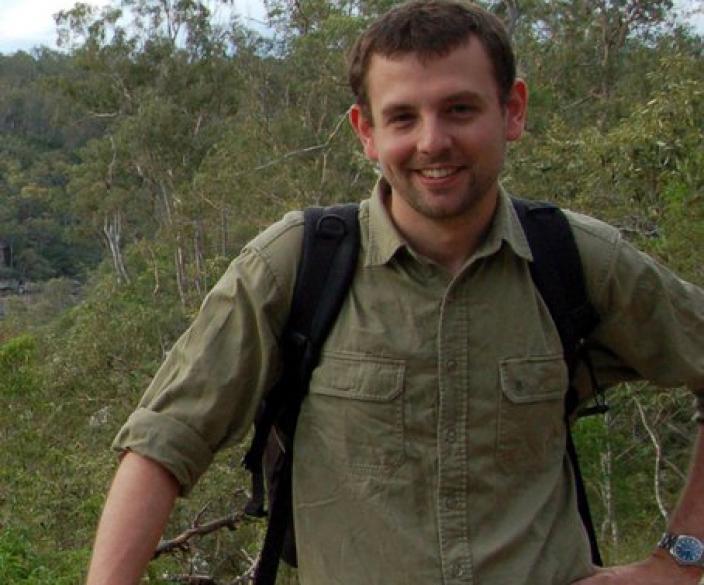 Michael Rix standing on a balcony in the bush