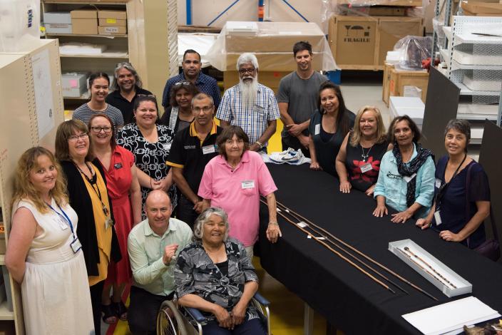 A group of people stand posing for the camera in the collection