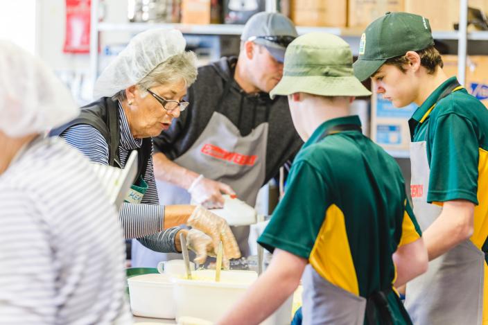 Young and older volunteers working at the catering station