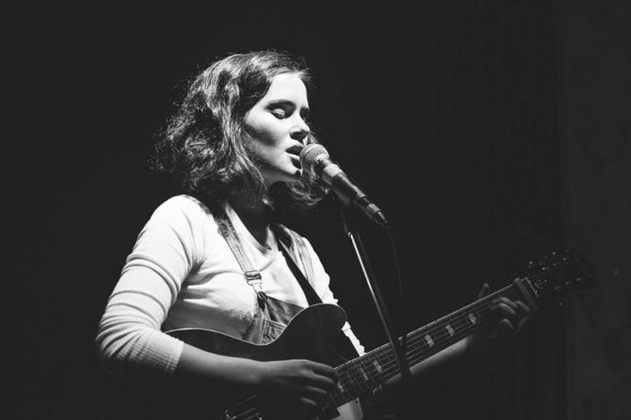 Local Perth artist, Grace, Grace singing and playing the guitar