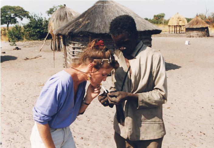 A friend lights Karen’s cigarette using flint andraw cotton A friend lights Karen’s cigarette using flint and raw cotton.