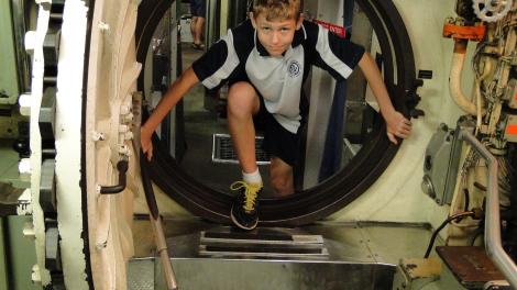 Boy coming through port hole at Maritime Museum