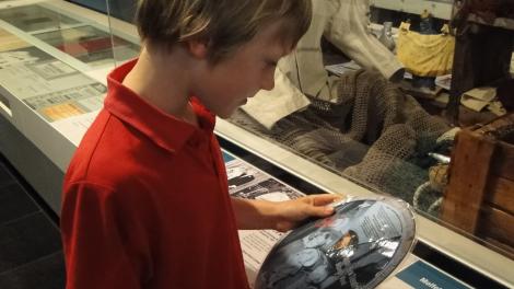 Boy looking at object in Maritime Museum