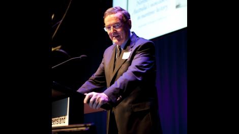 Portrait view of Professor Alan Powell presenting at a conference