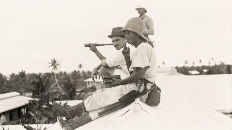 The Last Gentleman of War - Image copyright WA Museum Two people sitting on a roof top watching a naval battle