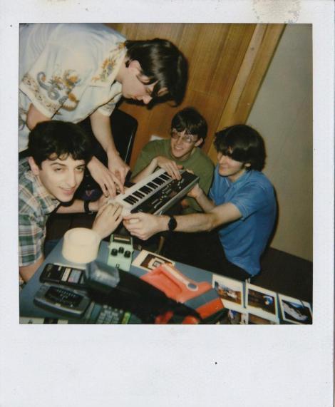 Polaroid photograph from 1995 showing four young band members playing casiotone