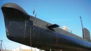 Caption: The HMAS Ovens. - Image copyright Western Australian Museum "The HMAS Ovens sat on the World War Two submarine slipway. The 89 metre long vessel is completely black, and stands tall above the dock below it."