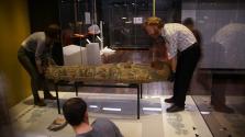 Preparing a sarcophagus for display in the exhibition