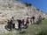Examining the limestone cliff looking for fossils