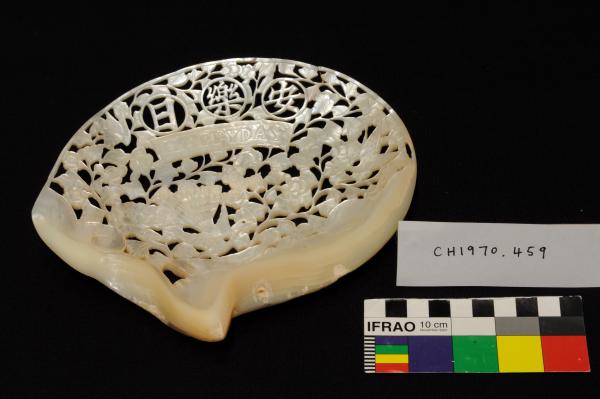 ORNAMENT OF CARVED PEARL, with wooden stand