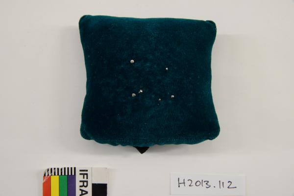 PIN CUSHION, green velvet, roughly square with elastic attachment