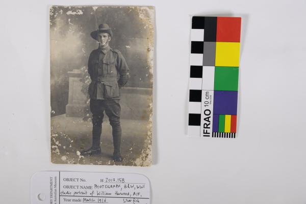 PHOTOGRAPH, B&W, full WWI studio portrait of William Harwood, AIF, March 1916. Silver fish damage.