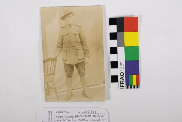 PHOTOGRAPH, B&W, full WWI studio portrait of Matthew Harwood, AIF, holding chair, c. 1917