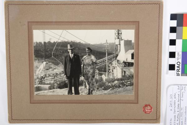 PHOTOGRAPH, B&W, mounted. Matthew and Gladys Harwood standing in front of Canning Dam works, WA.