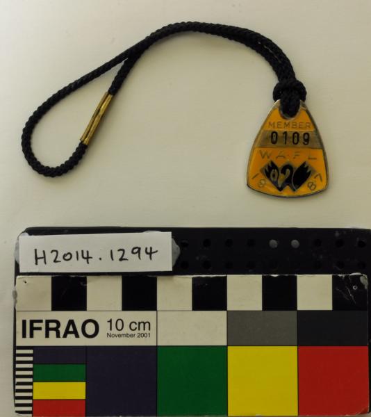 IDENTIFICATION BADGE, metal, enamelled, triangular, gold/black, on black cord, 'MEMBER/ W.A.F.L./ 1987'