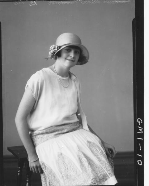 Portrait of a young woman seated short sleeve dress and hat, 3/4,'Wird?'.