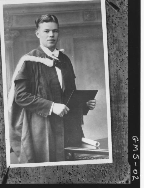 Board pinned copy of portrait of young man in graduation robes, Mrs Lucich.