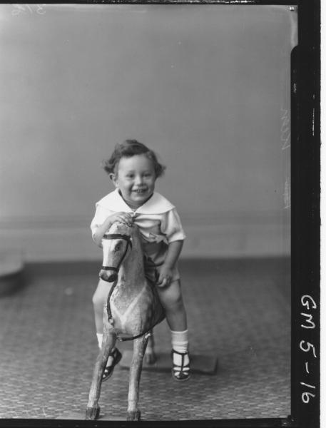 Portrait of young child on rocking horse, F/L Keen.