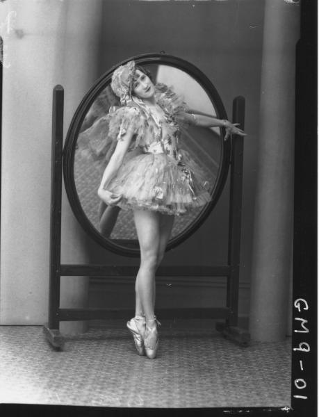 Portrait of woman dancer in costume, F/L Leaared.