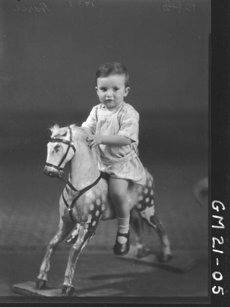 portrait of small child on rocking horse F/L, Harse