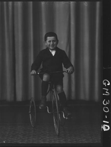 portrait of young boy riding tricycle, F/L Pysing