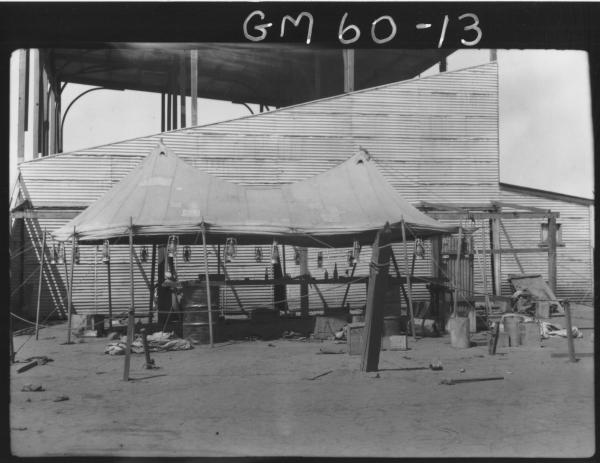 Camp with canvas roof used for car mechanics