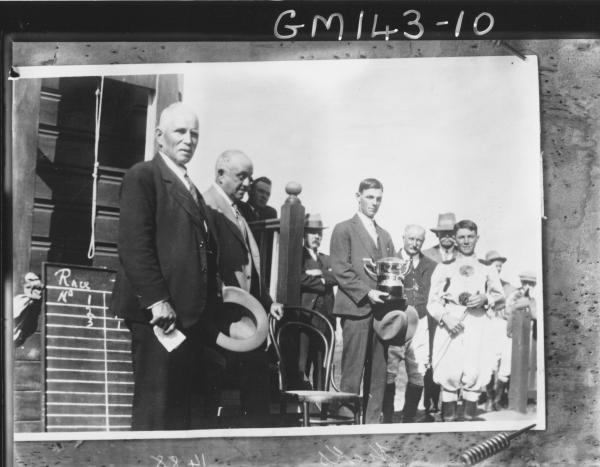 Copy of racing group presenting cup to Jockey 'Hicks'