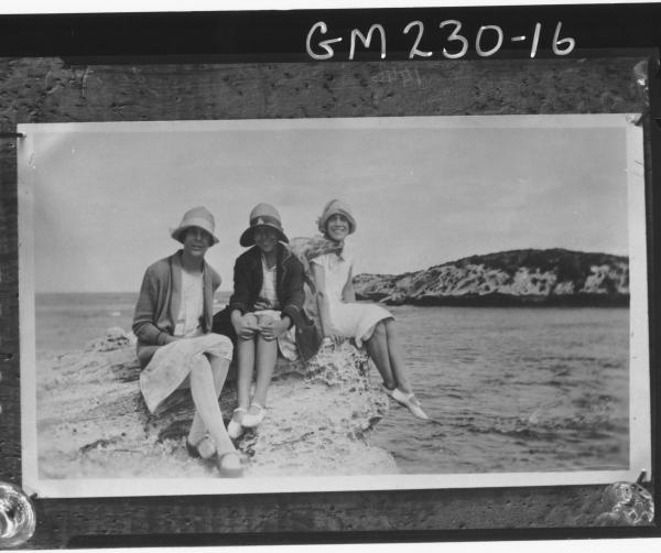 Copy of three women 'Jones' sitting on rocks by the sea