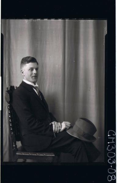 3/4 Portrait of man seated, wearing suit, holding hat, side view; 'Smith'