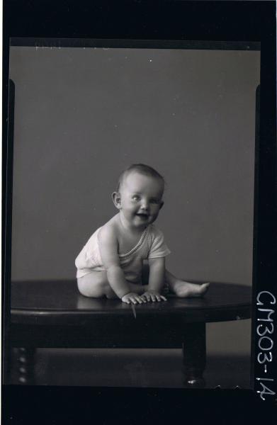 F/L Portrait of baby seated on table wearing vest; 'Sheehan'