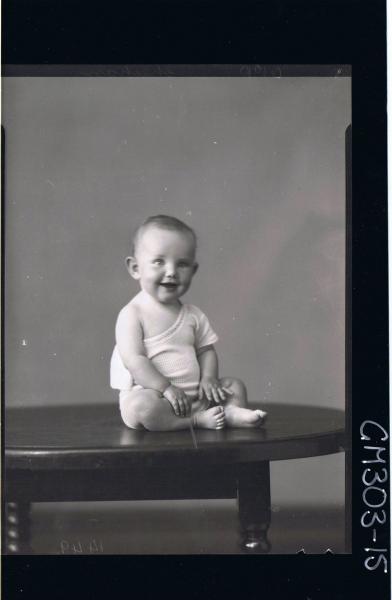 F/L Portrait of baby seated on table wearing vest; 'Sheehan'