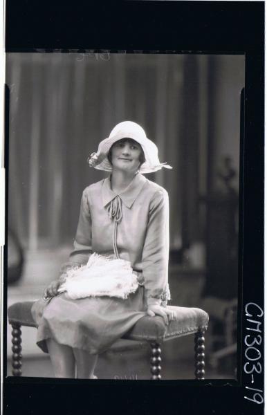 3/4 Portrait of woman, seated wearing three quarter length dress, holding feather fan; 'Smith'