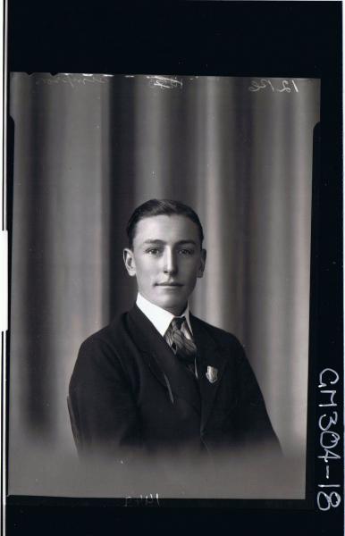 H/S Portrait of young man wearing shirt, tie, jacket with badge on collar; 'Simpson'