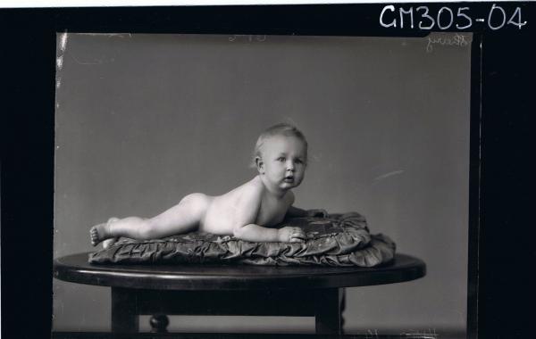F/L Portrait of naked baby, lying on table; 'Sherry'
