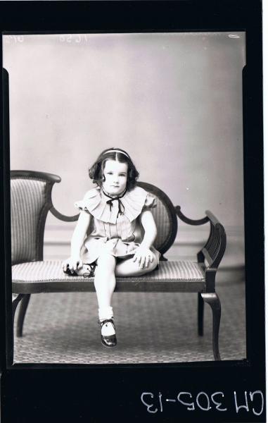 F/L Portrait of girl seated, wearing short dress with pleats and pleated collar; 'Mun?ard P. C.'